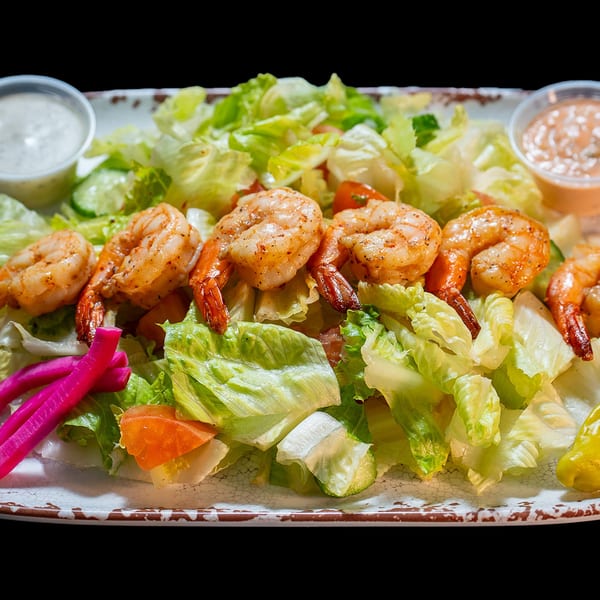 Grilled shrimp salad with lettuce, tomatoes, cucumbers, pickled turnips, and two dipping sauces.